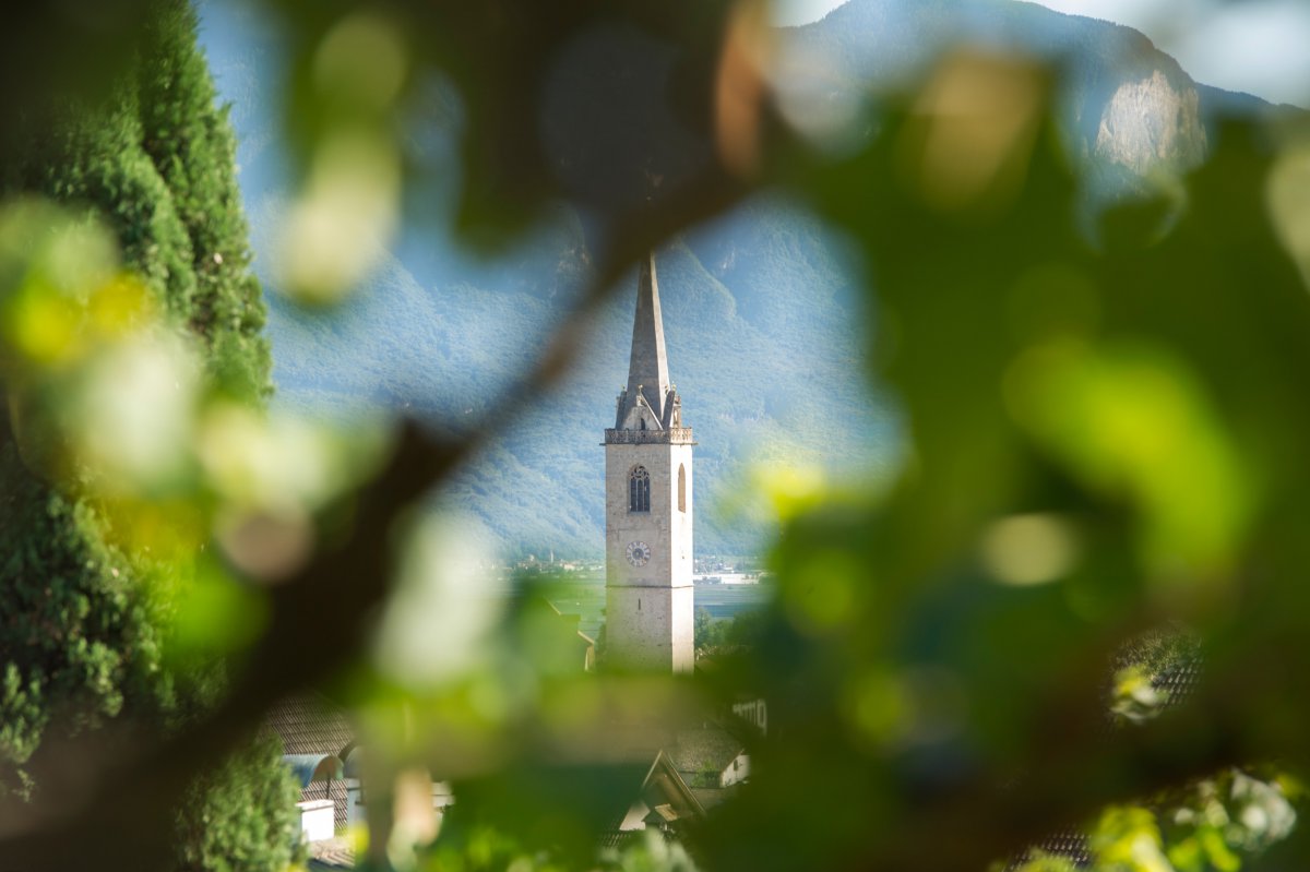 Breathtaking view of the Kaltern church tower from the vineyards near Hotel Torgglhof in Kaltern.